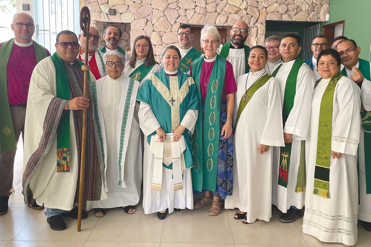 Group photo of bishops and clergy wearing clerical clothing.